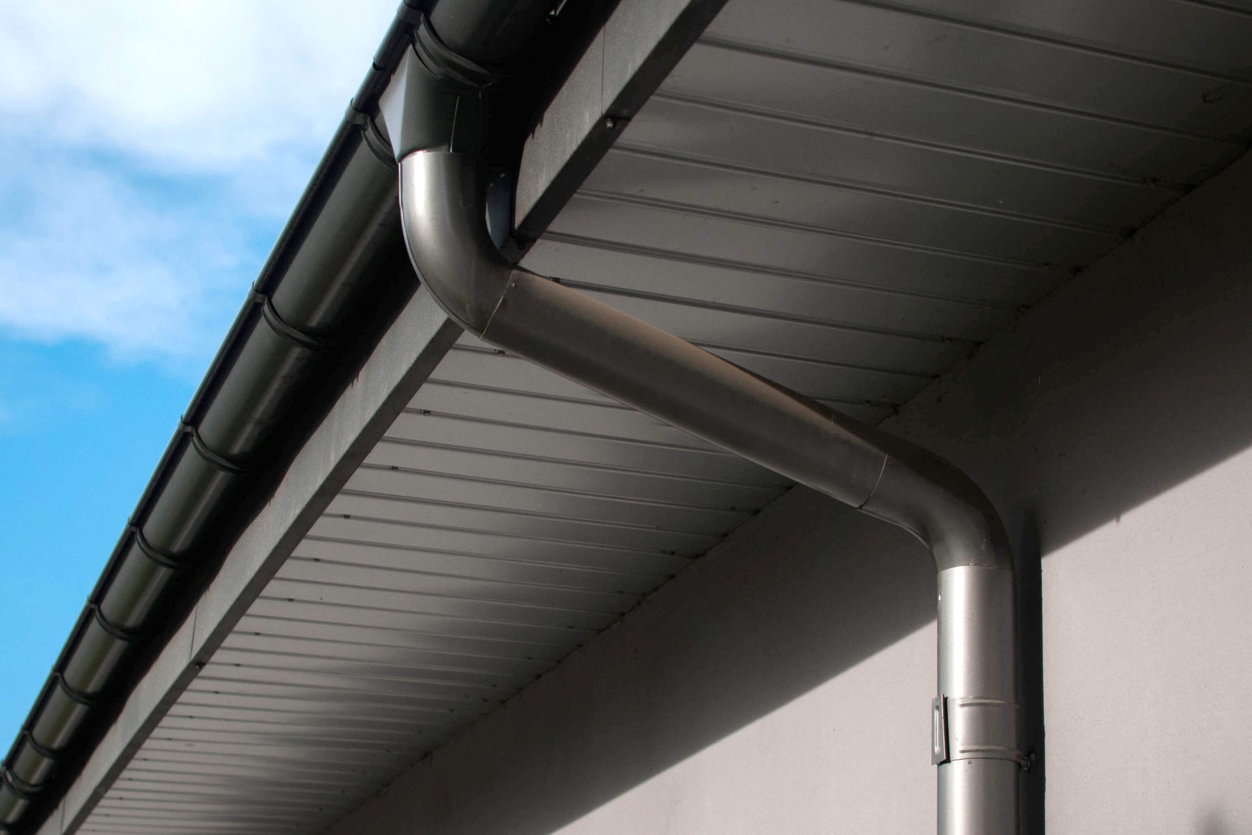 Corrosion-resistant galvanized gutters installed on a commercial building in New Braunfels